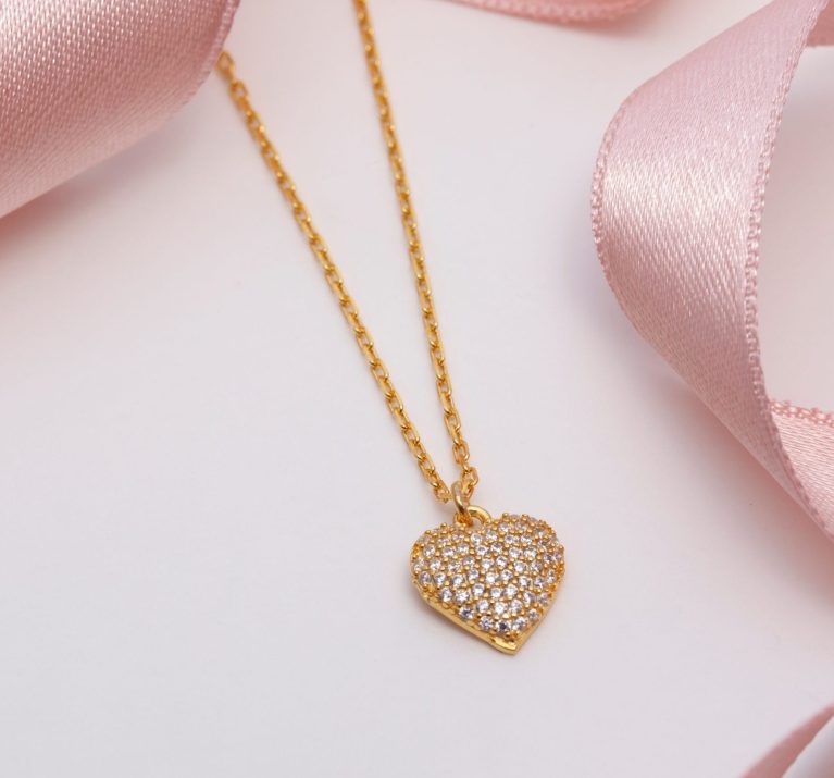 Diamond-encrusted,Gold,Women's,Necklace,With,Pink,Ribbon,On,A,Soft